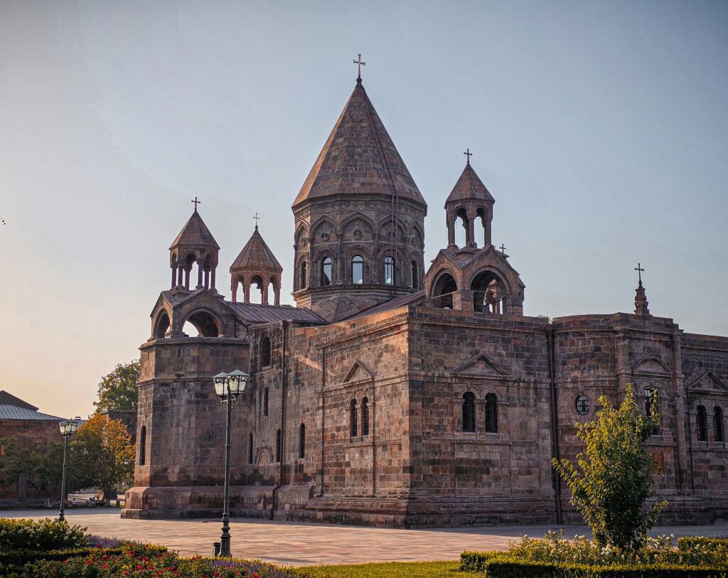 Echmiadzin Cathedral glowing in the evening light, showcasing Armenian architecture.